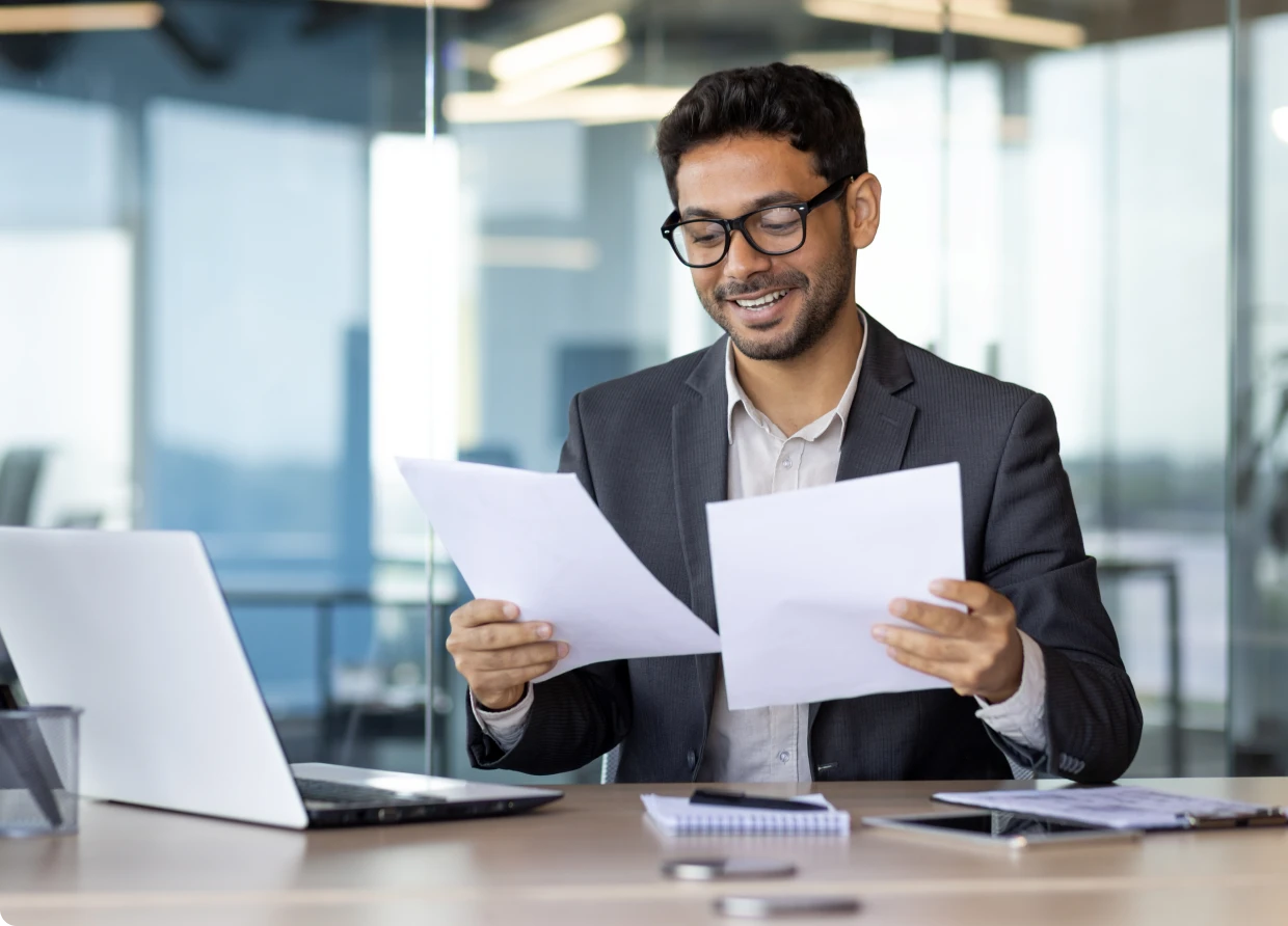 Businessman smiling with papers